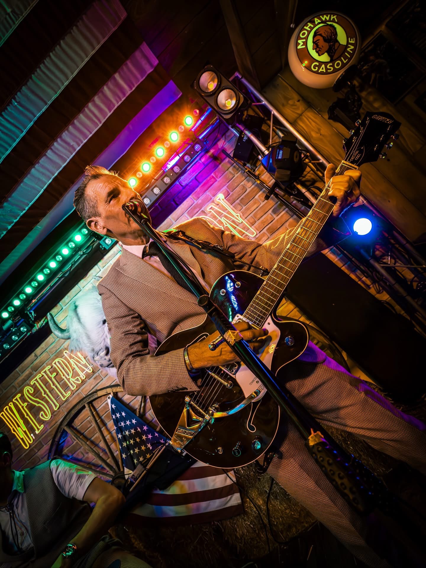 Guitarist at the Western Saloon, dramatic coloured lighting