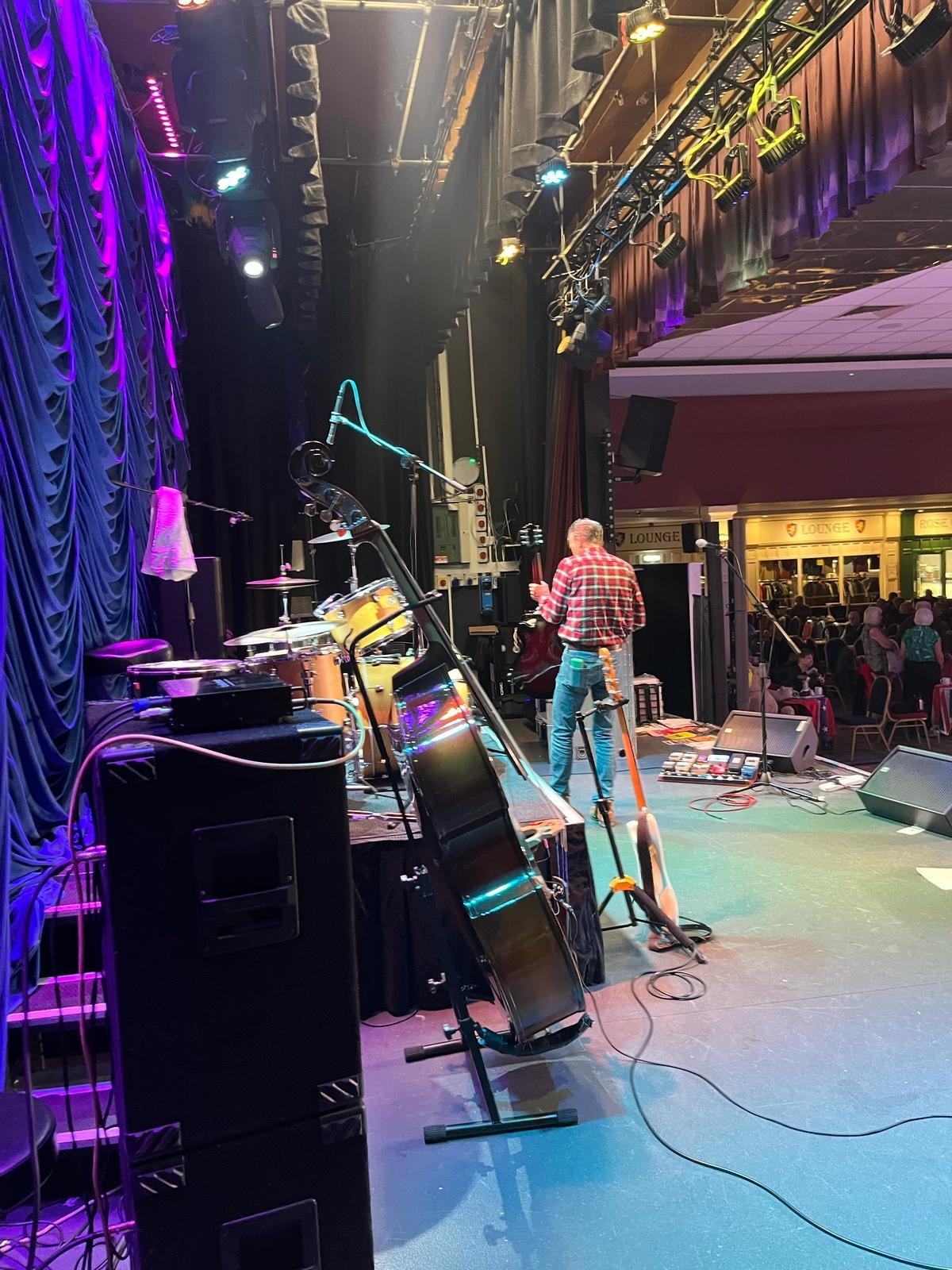 Live performance with neon purple and cyan lighting