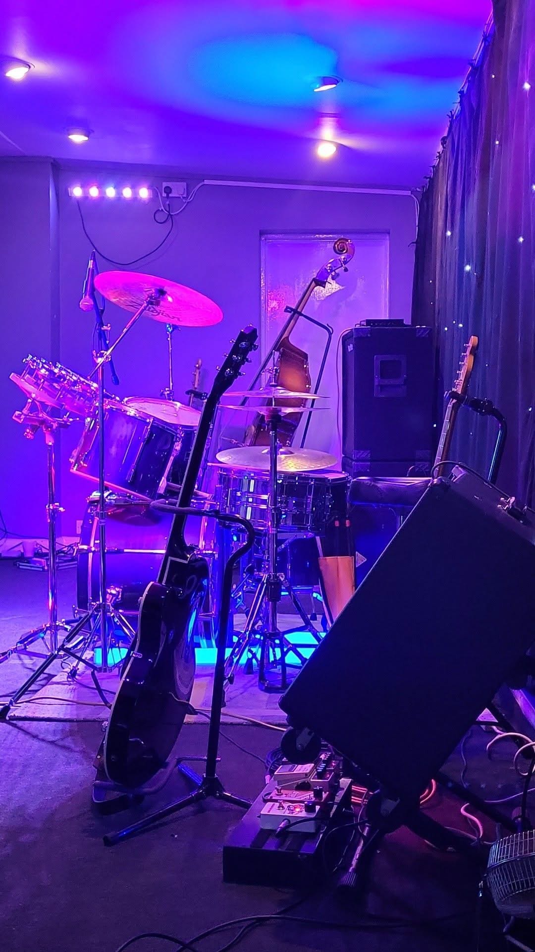 Neon lit music studio with instruments