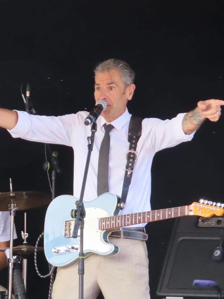 Vocalist and guitarist performing — great energy shot